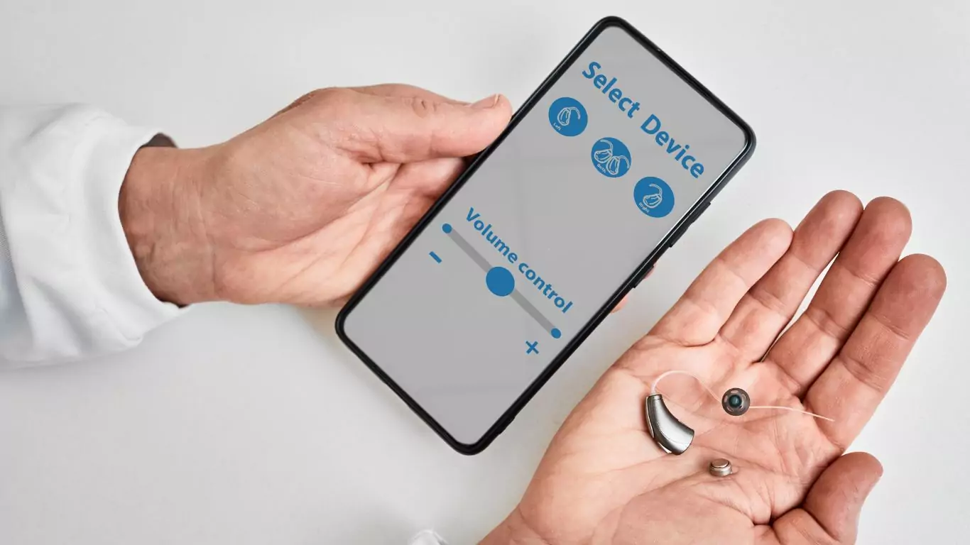 An image of a audiologist showing smartphone app for adjusting hearing aid