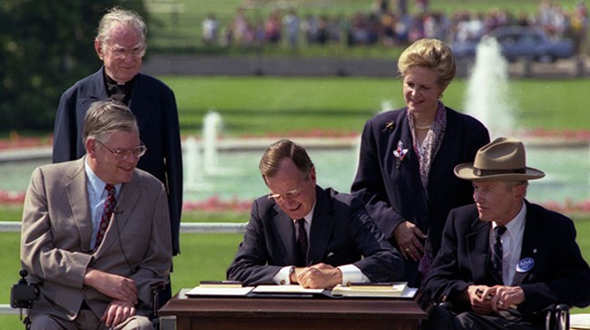 President George H.W. Bush, signing the Americans with Disabilities Act (ADA) into law July 26, 1990.