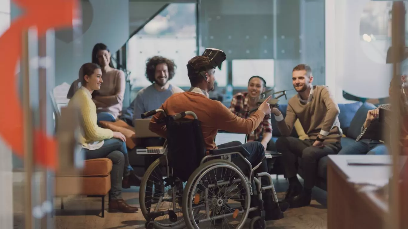 A group of diverse people with a man in a wheelchair
