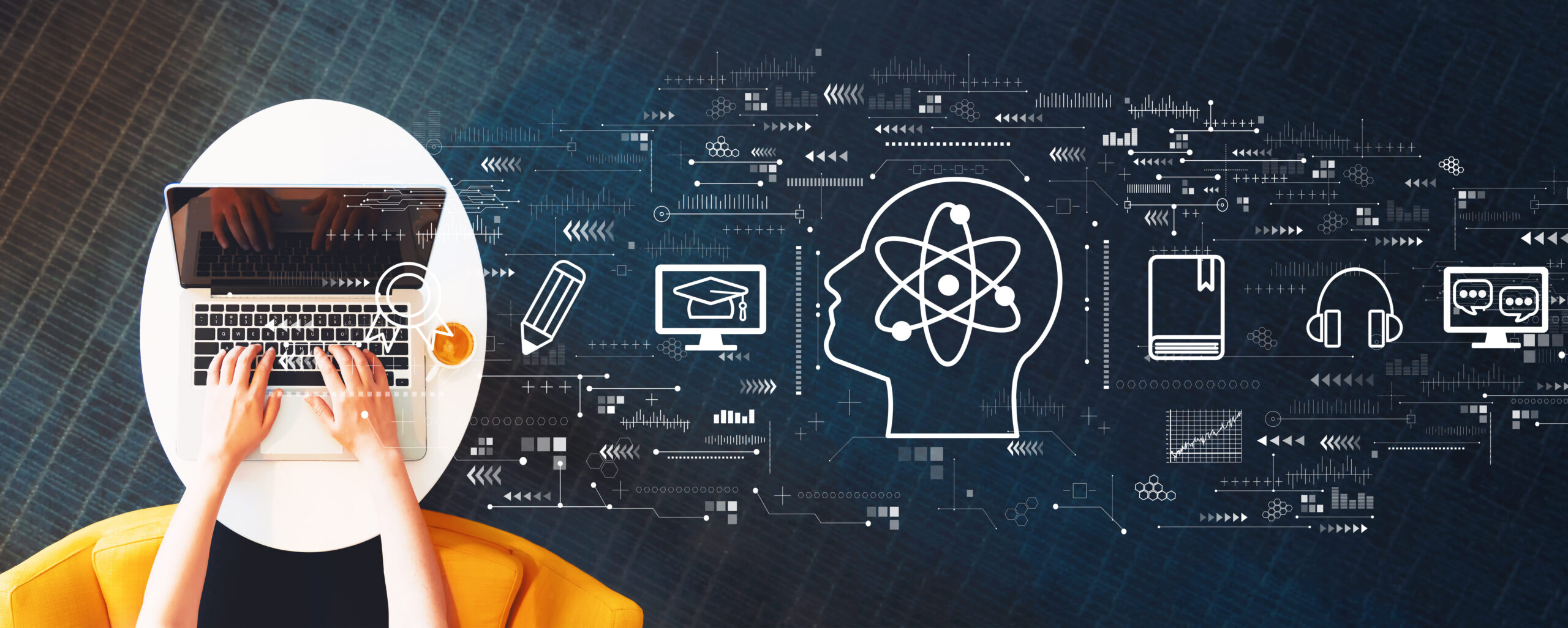 blue background with white graphics of various digital designs, including computers, tablets, and symbols. A head with atoms inside is in the center. At left is a persons hands typing on a laptop.