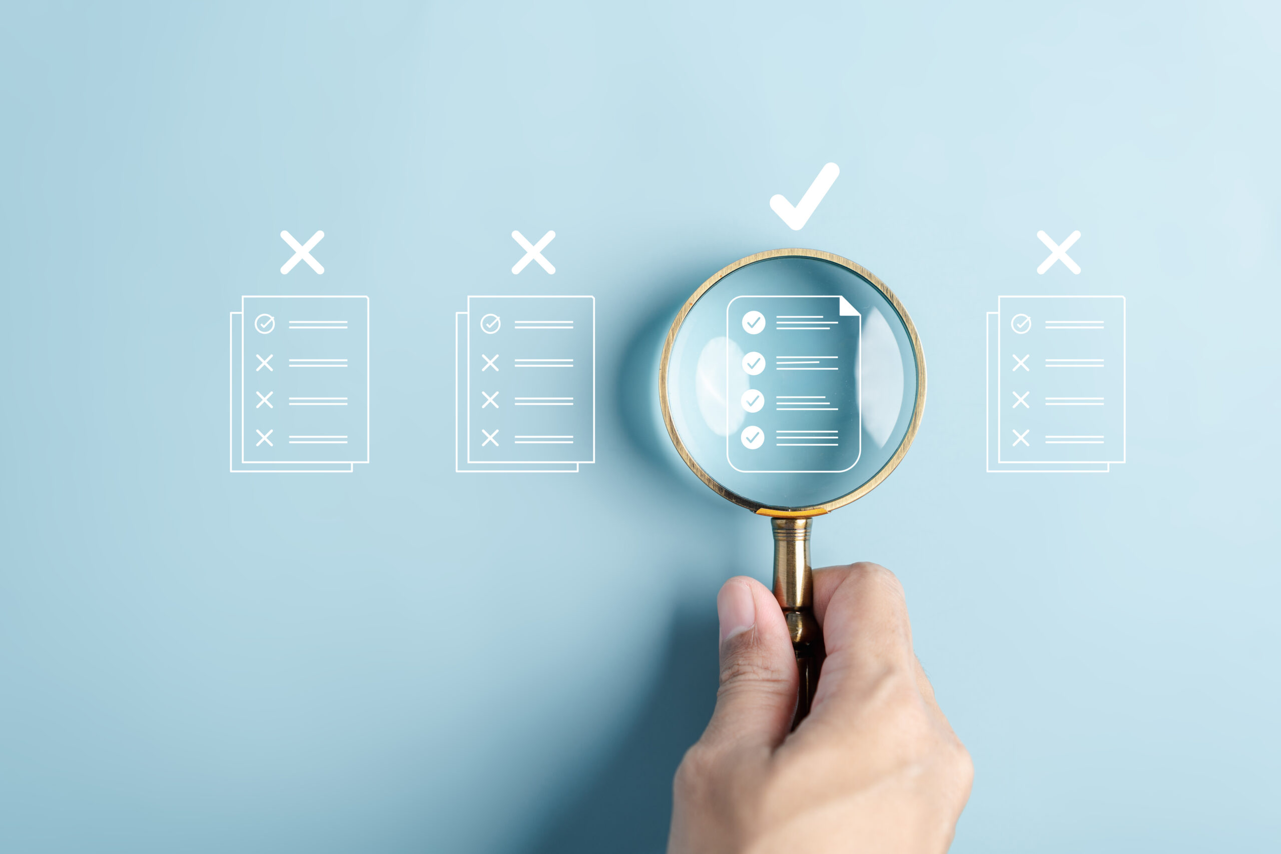 Four checklist icons in a row. A hand with magnifying glass is over the third one. It also has a checkmark above it, while the other three have X's.